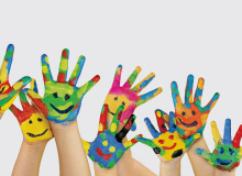 children's hands painted with bright vibrant colors and smiley face drawings