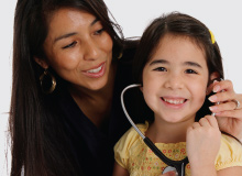 mother and daughter smiling and playing with stethoscope